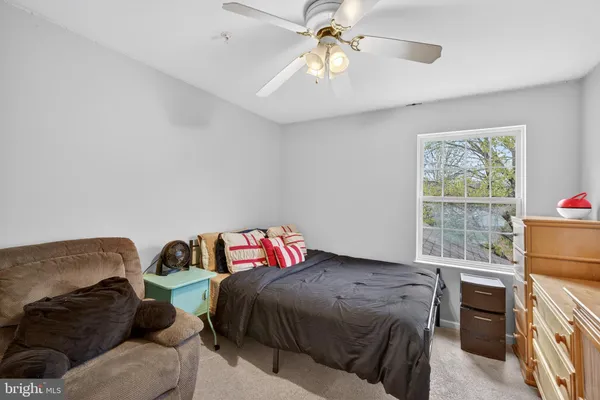 a spacious bedroom with a bed and cabinets
