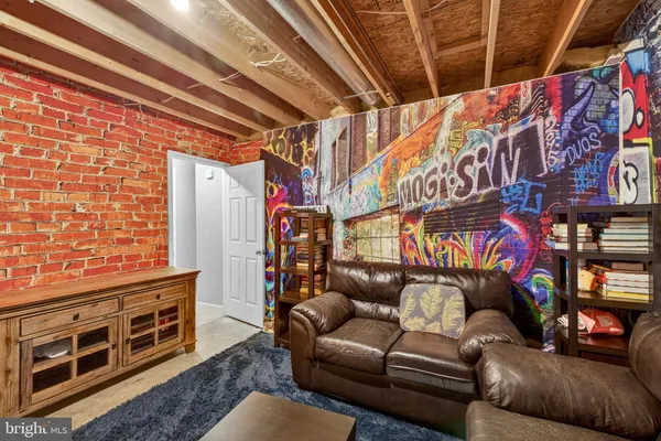 a view of room with hardwood flooring and furniture