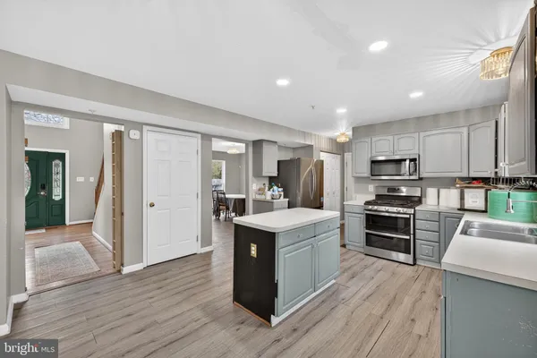 a kitchen with a sink stove and cabinets