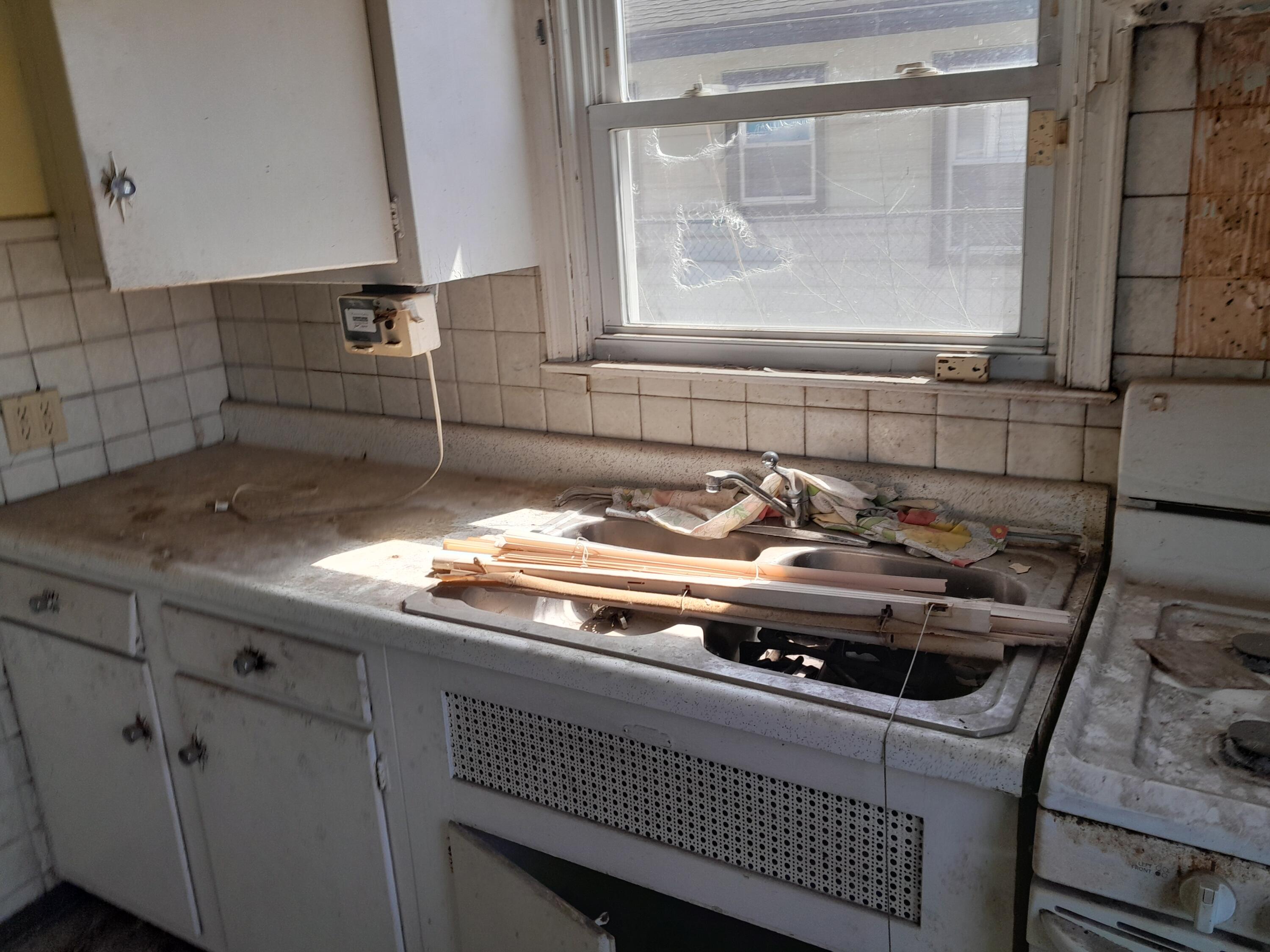 266 Johnson Street Gary, IN 46404 - Photo 8 of 16 a close view of sink a faucet and a stove in a kitchen