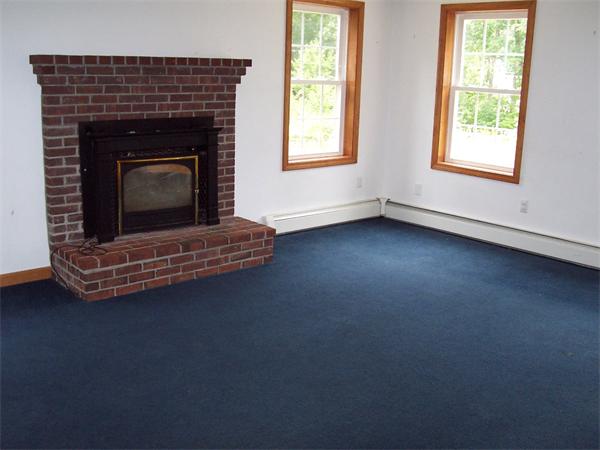 475 Riceville Road Athol, MA 01331 - Photo 3 of 9 an empty room with fireplace and window
