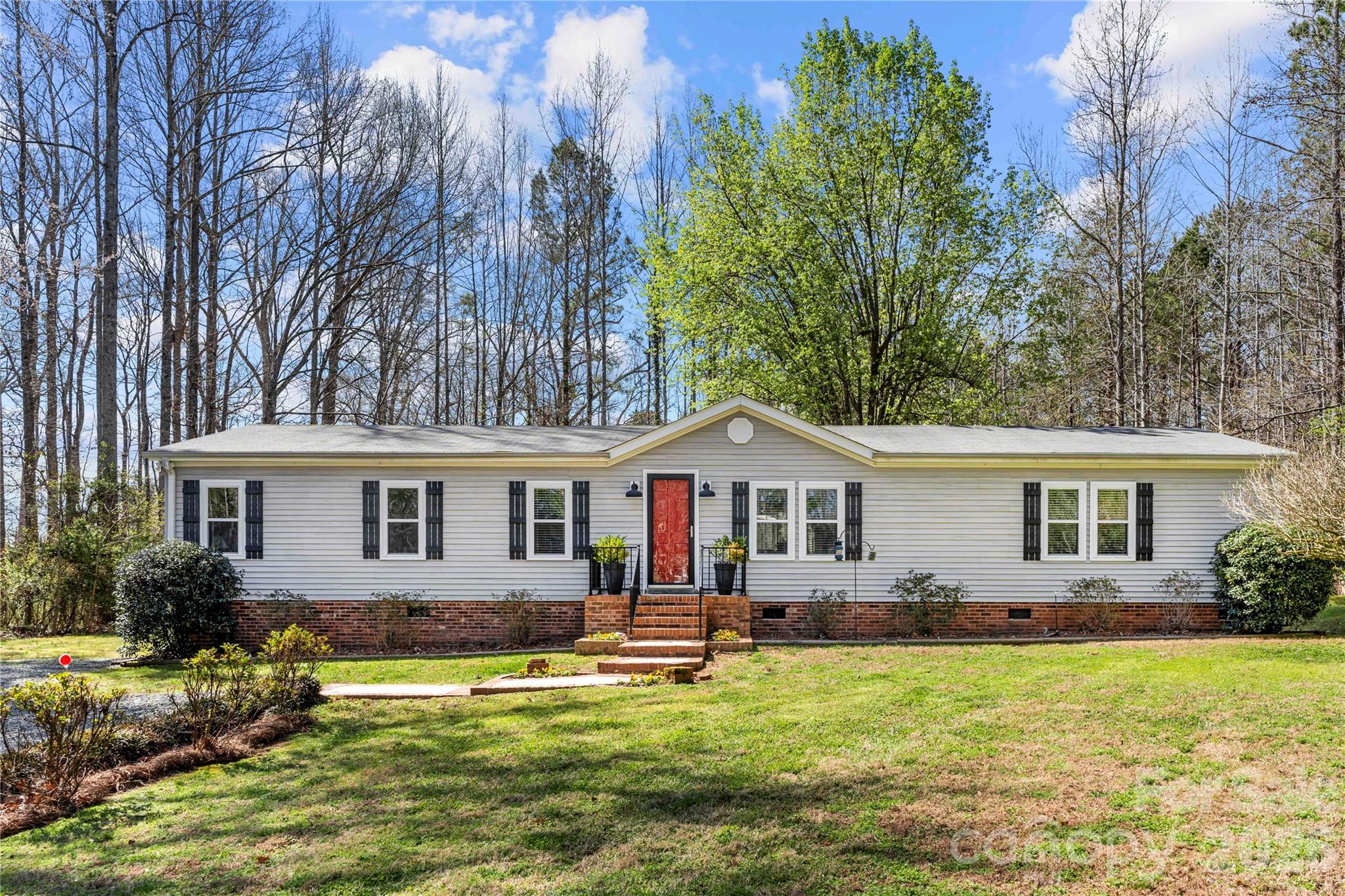 a front view of house with yard and green space