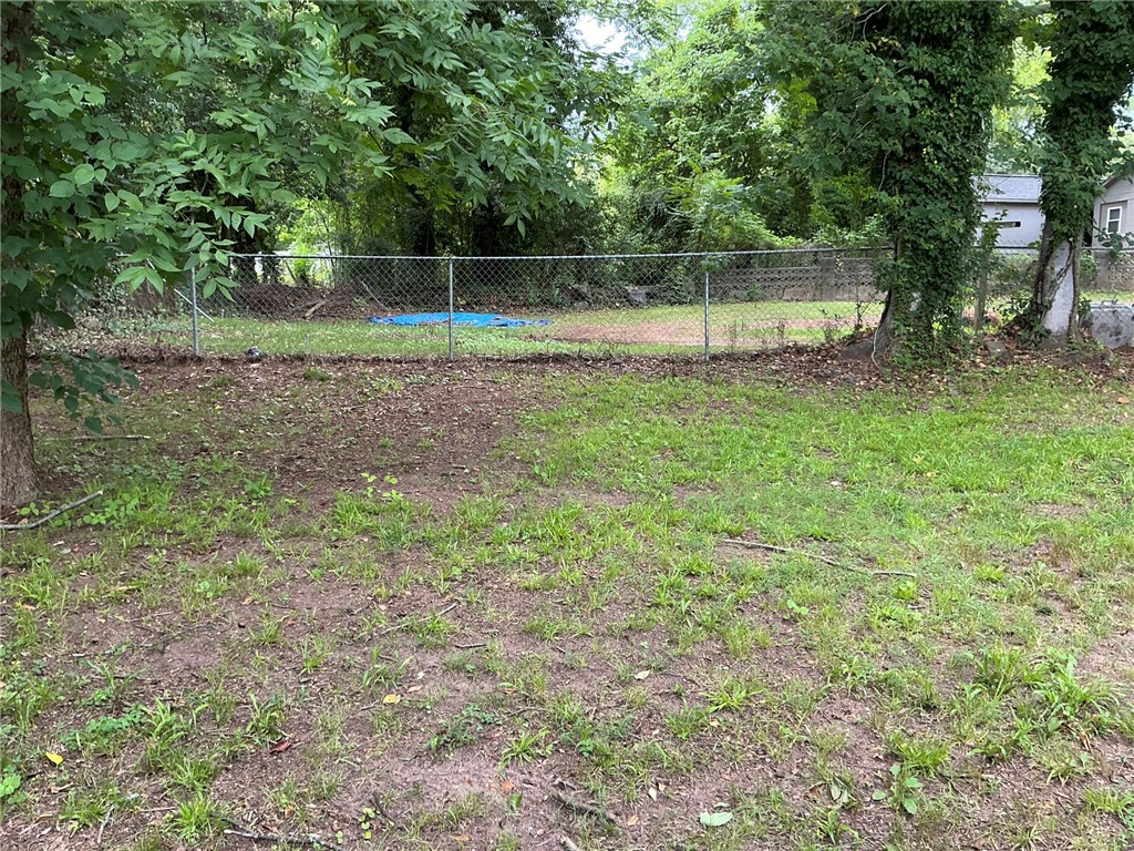 504 Caughlin Avenue Anderson, SC 29624 - Photo 15 of 15 A well-maintained yard provides ample space for outdoor activities, bordered by a secure chain link fence.