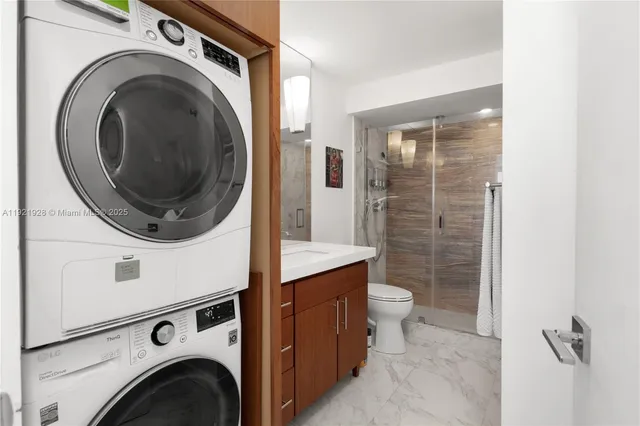 a view of a storage and utility room with washer and dryer