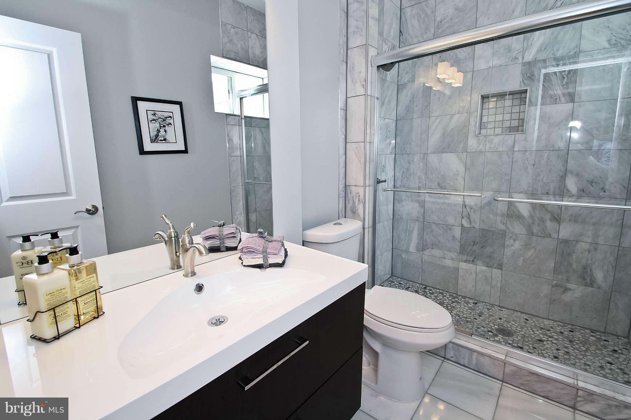 604 Columbia Road Northwest Washington, DC 20001 - Photo 12 of 25 a bathroom with a sink toilet and shower