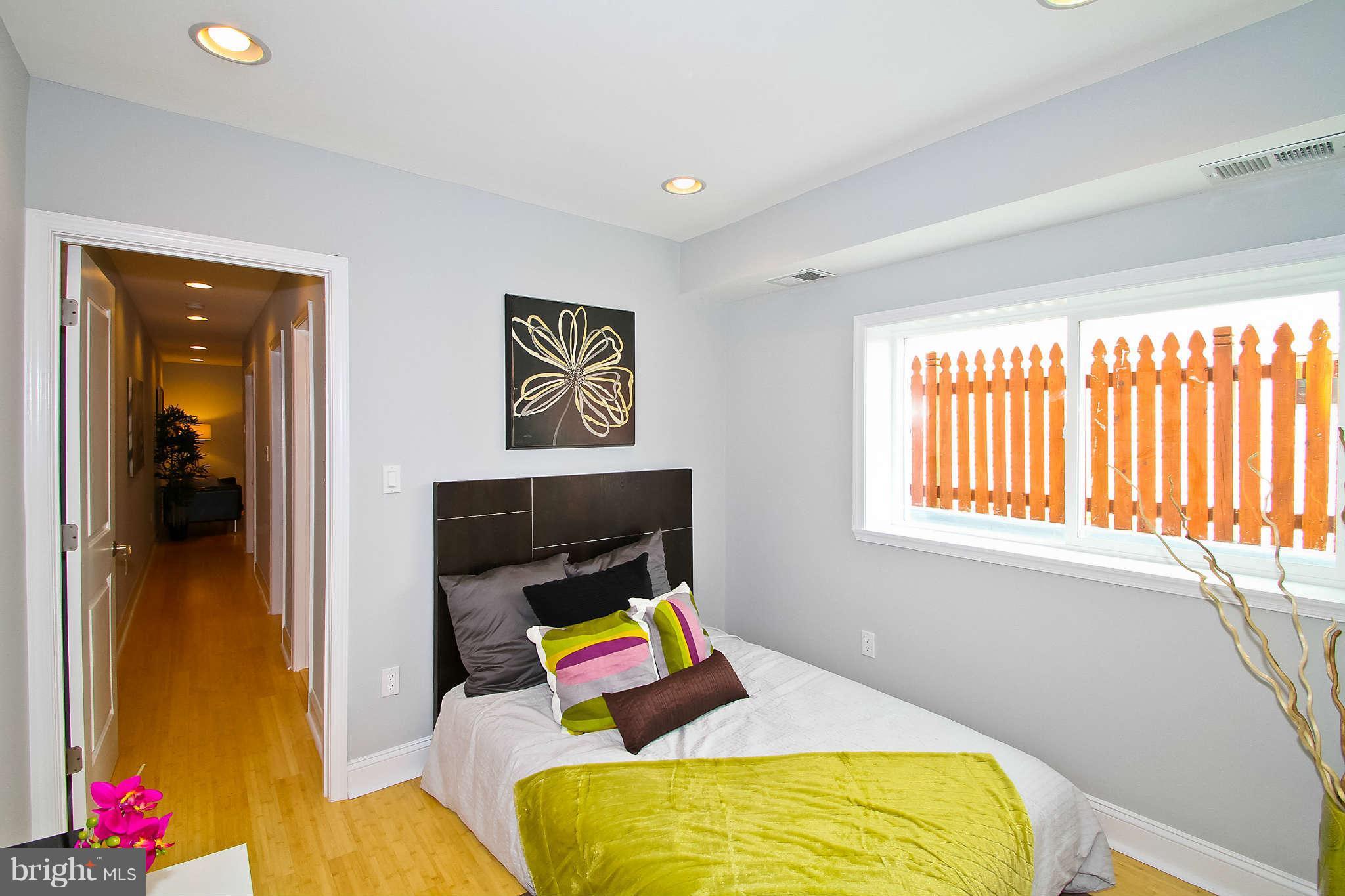 604 Columbia Road Northwest Washington, DC 20001 - Photo 20 of 25 a bed room with a bed furniture and a window