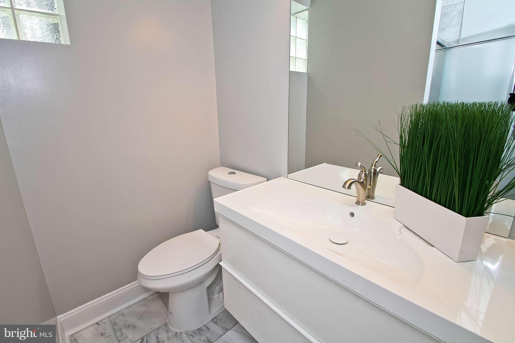 604 Columbia Road Northwest Washington, DC 20001 - Photo 21 of 25 a white toilet sitting next to a bathroom sink