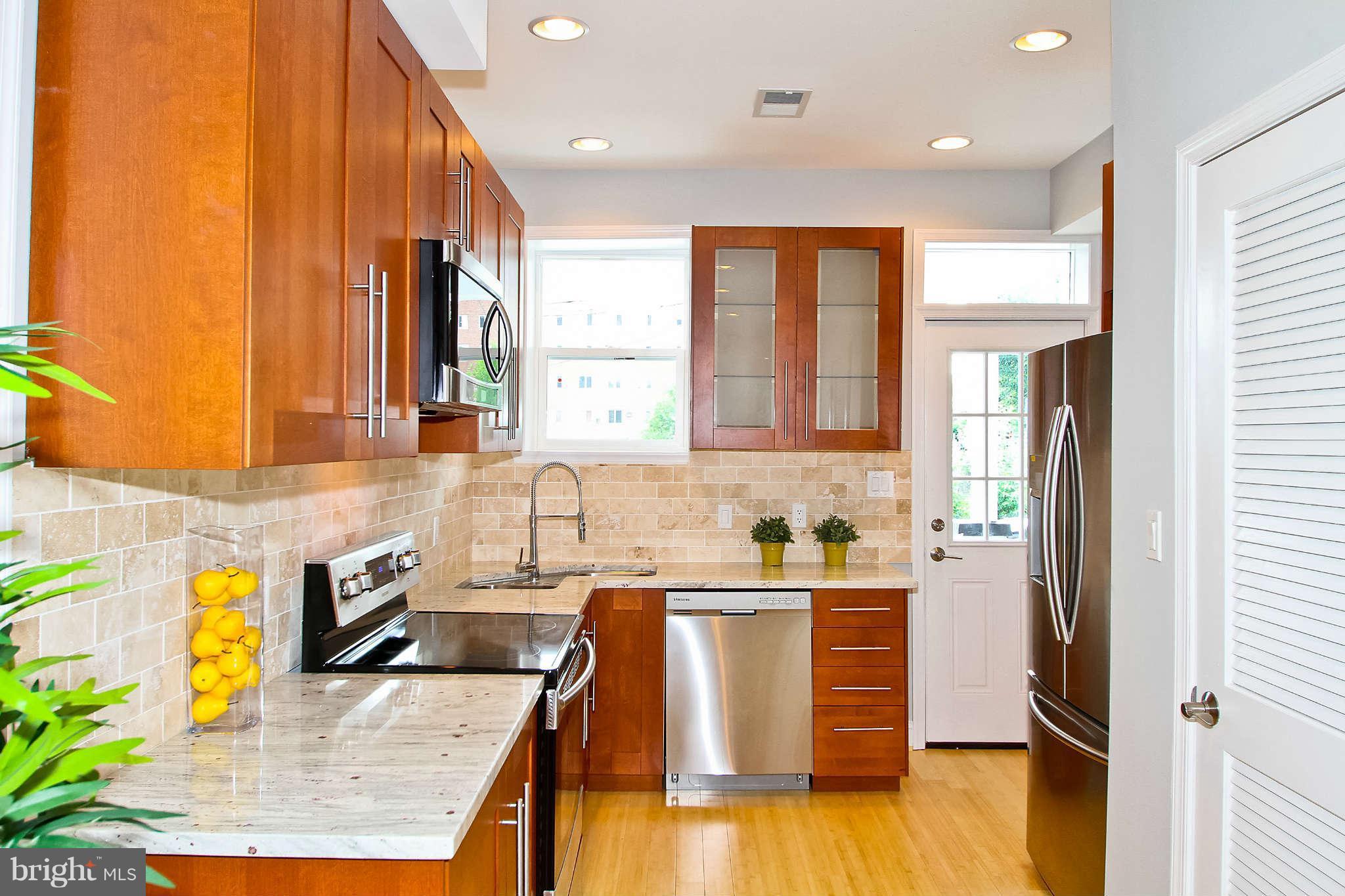 604 Columbia Road Northwest Washington, DC 20001 - Photo 6 of 25 a kitchen with a sink a counter top space and appliances