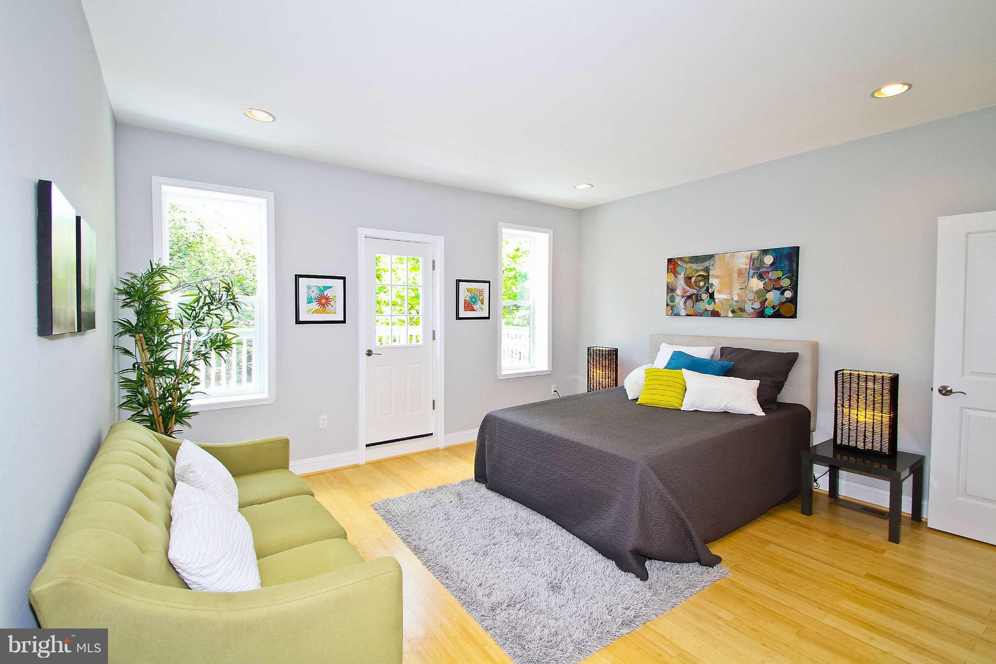 604 Columbia Road Northwest Washington, DC 20001 - Photo 7 of 25 a bedroom with a bed and a couch