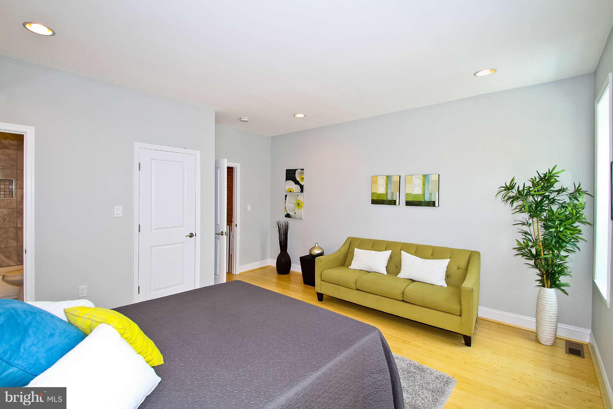 604 Columbia Road Northwest Washington, DC 20001 - Photo 8 of 25 a bedroom with a bed and a couch