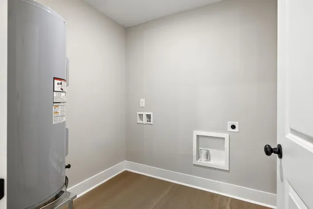 a view of a small space with wooden floor and a window