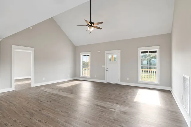 wooden floor in an empty room with a window