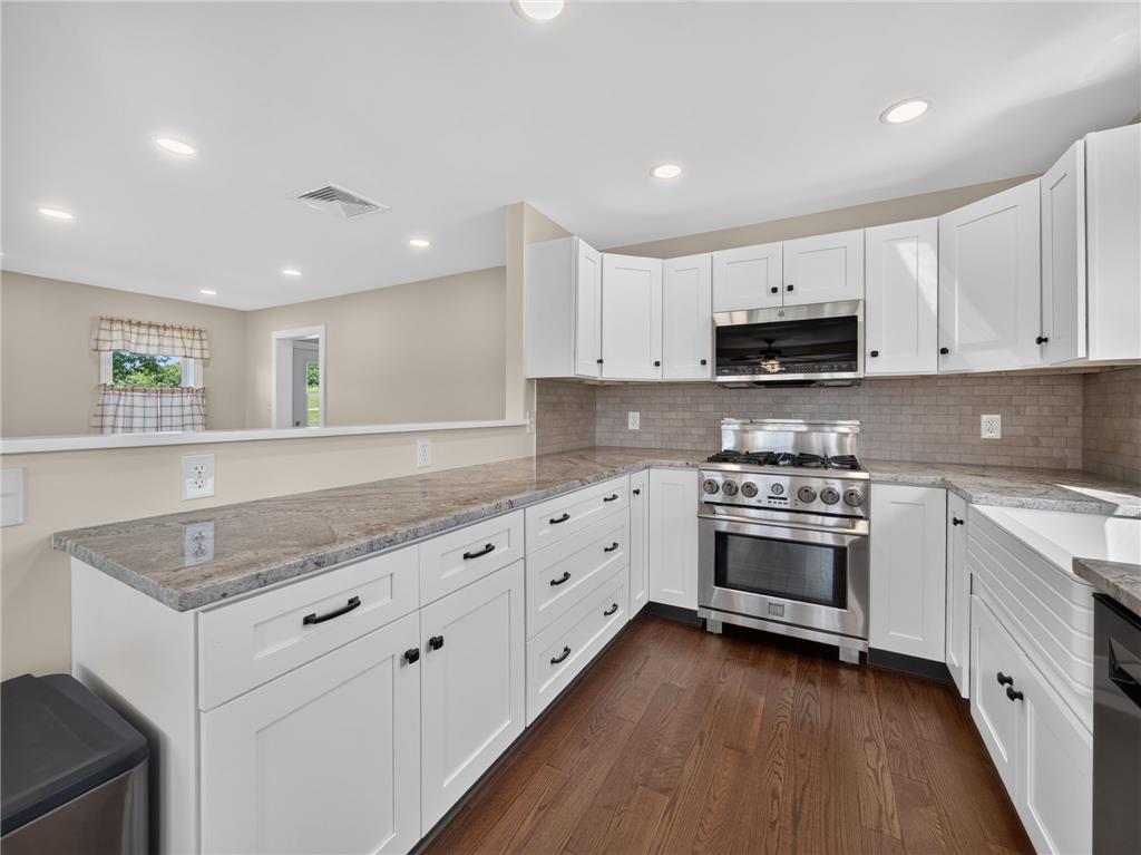 291 East Dannersville Road Bath, PA 18014 - Photo 31 of 46 A well-appointed kitchen showcasing rich hardwood flooring and sleek stone countertops, perfect for culinary endeavors.