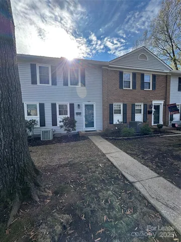 a view of a big house with a yard