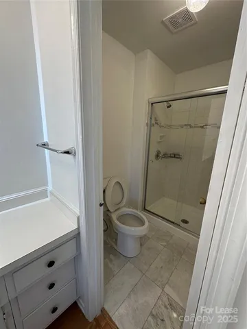 a bathroom with a shower and a toilet
