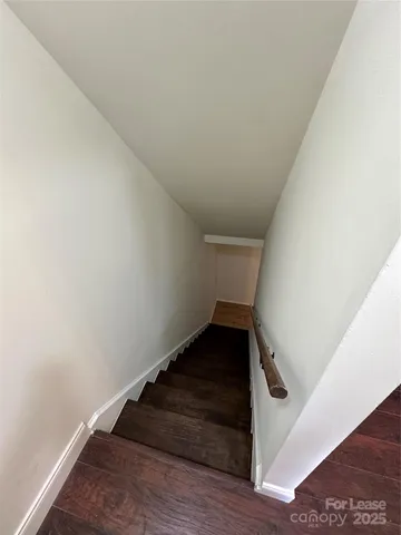 a view of an empty room and wooden floor