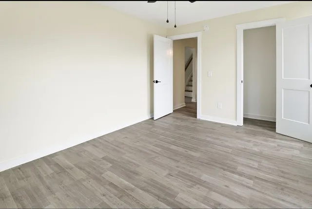 a view of an empty room with wooden floor