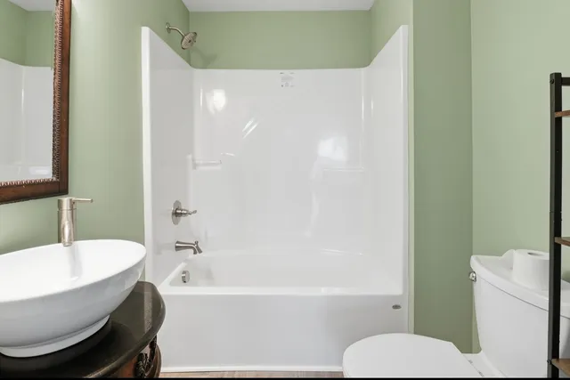 a bathroom with a toilet and a bathtub