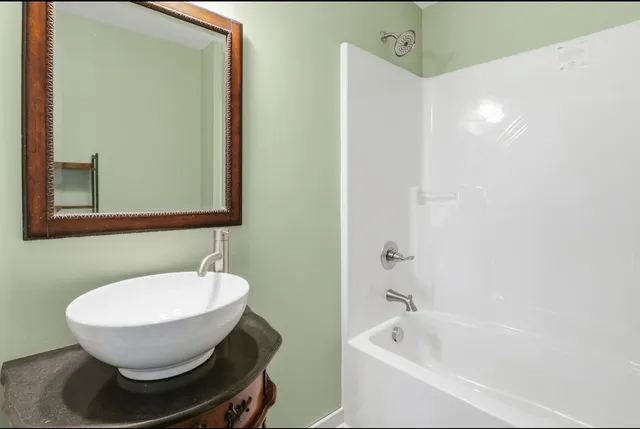 a bathroom with a tub and a sink