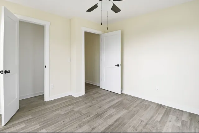 a view of a hallway with wooden floor