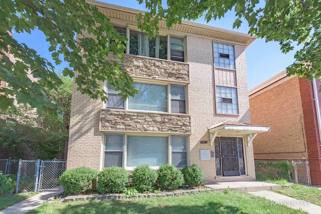 5942 West Addison Street, Unit 1 Chicago, IL 60634 - Photo 1 of 24 a view of a white house with a small yard plants and large tree