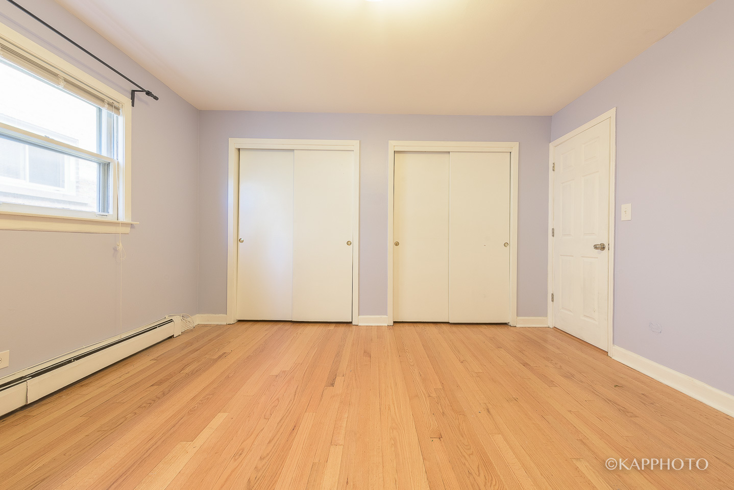 5942 West Addison Street, Unit 1 Chicago, IL 60634 - Photo 12 of 24 a view of an empty room with wooden floor and a window