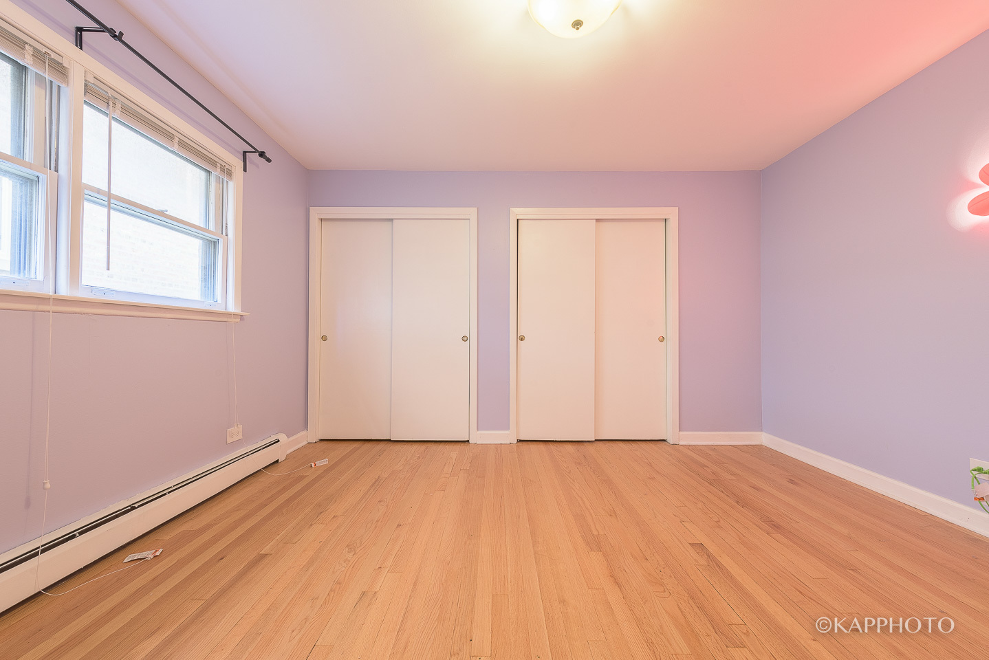 5942 West Addison Street, Unit 1 Chicago, IL 60634 - Photo 14 of 24 a view of an empty room with wooden floor and a window