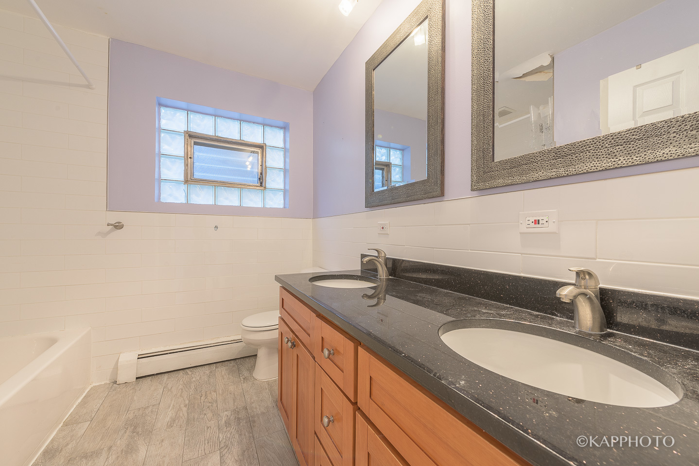 5942 West Addison Street, Unit 1 Chicago, IL 60634 - Photo 20 of 24 a bathroom with a granite countertop sink and a mirror