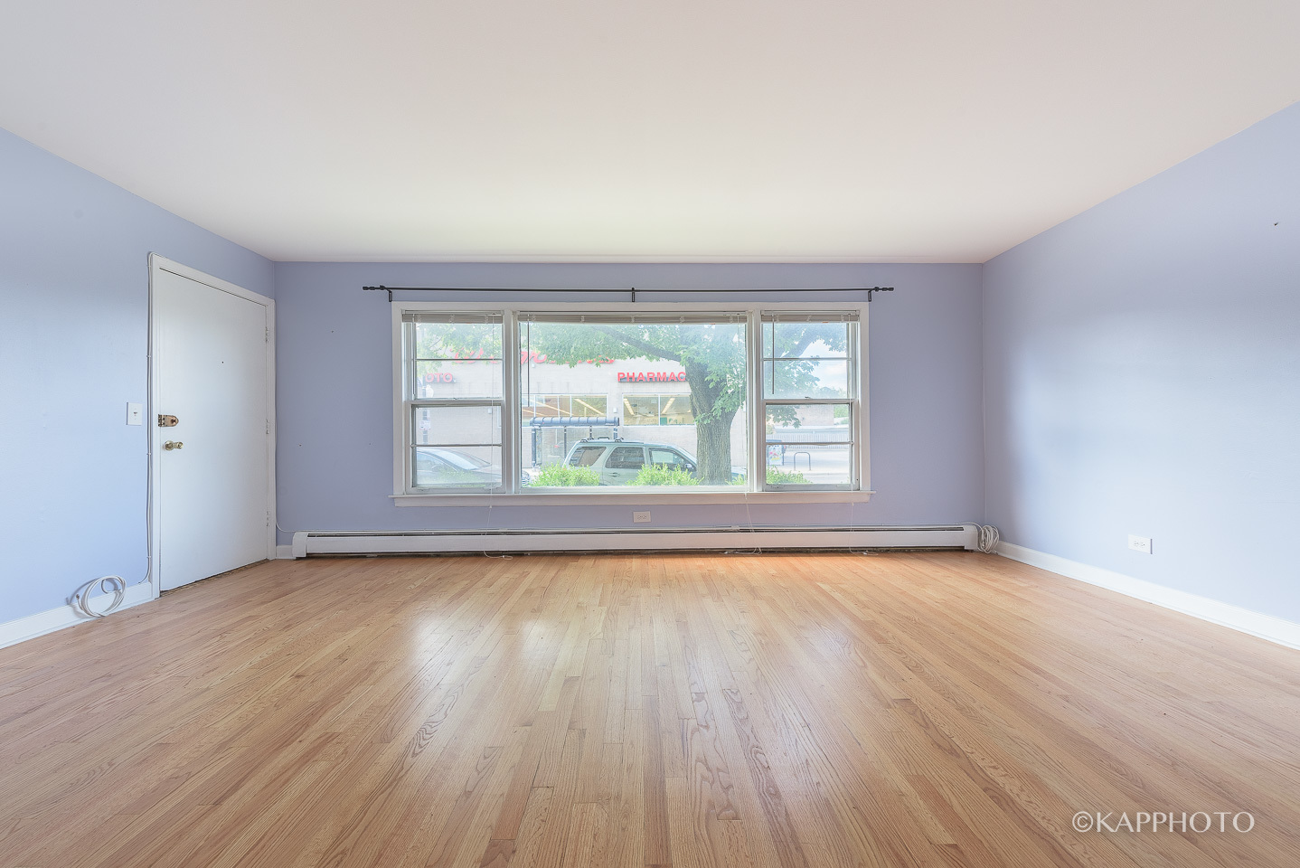 5942 West Addison Street, Unit 1 Chicago, IL 60634 - Photo 2 of 24 an empty room with wooden floor and windows