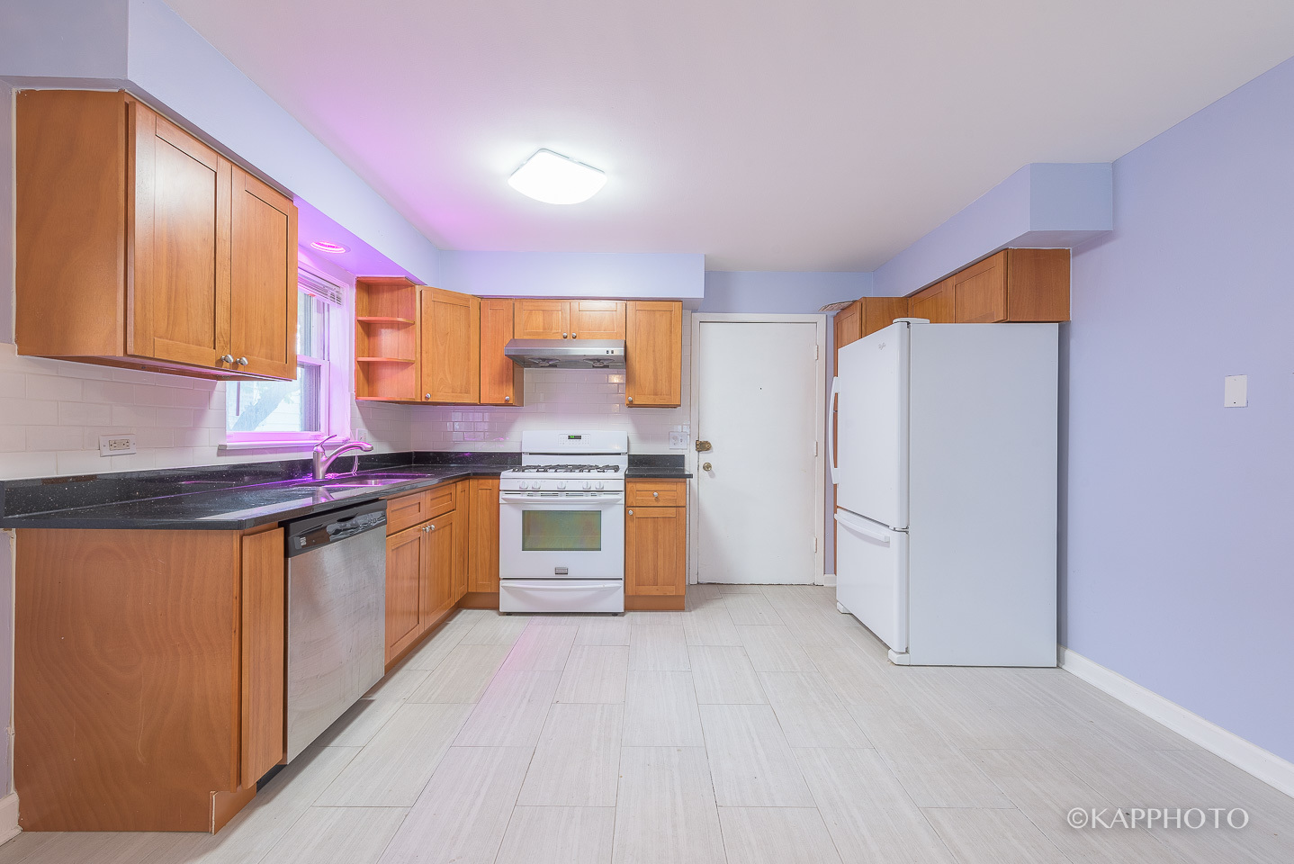 5942 West Addison Street, Unit 1 Chicago, IL 60634 - Photo 10 of 24 a kitchen with stainless steel appliances white cabinets and a refrigerator