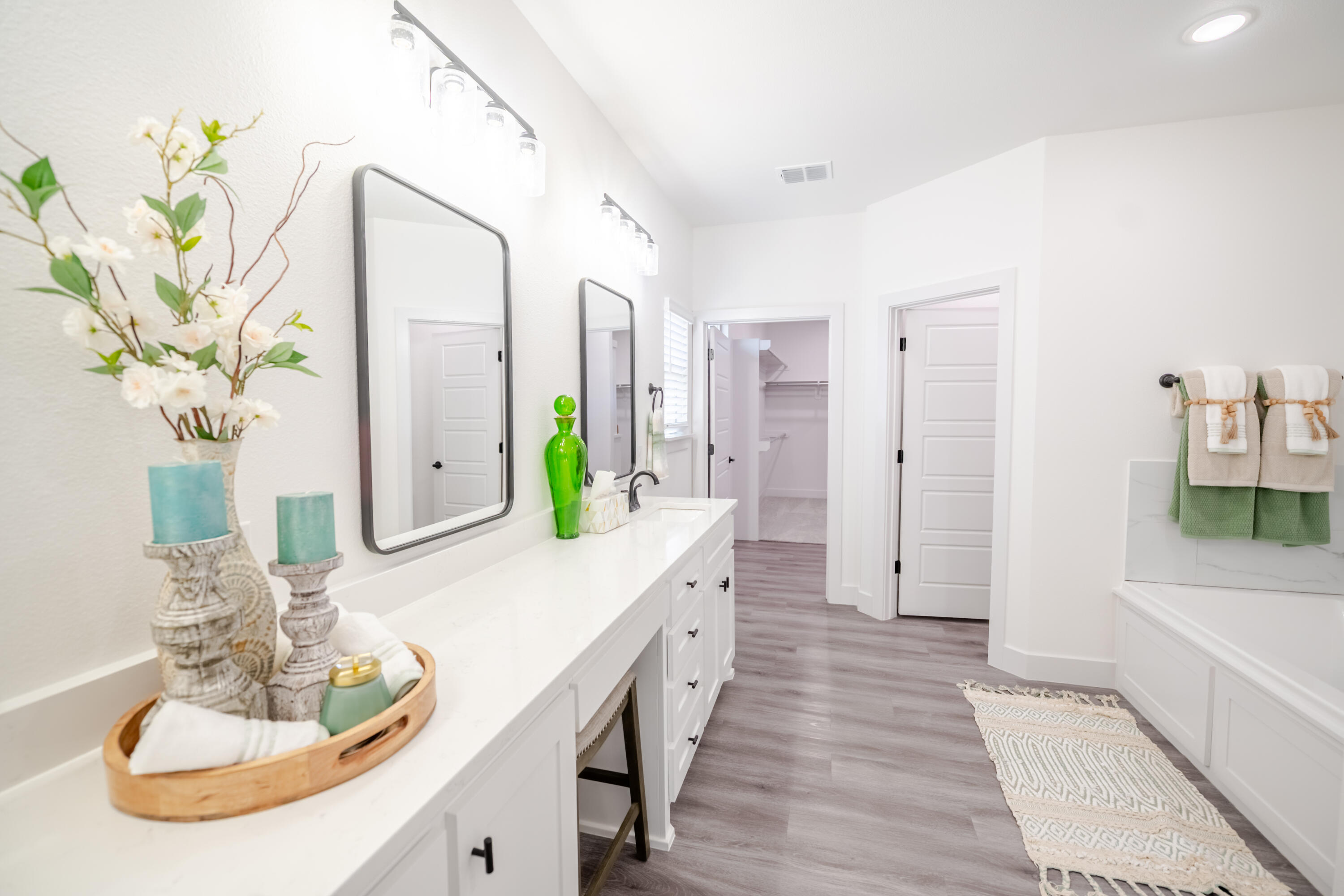7604 58th Street Lubbock, TX 79407 - Photo 14 of 38 a spacious bathroom with a double vanity sink and a mirror