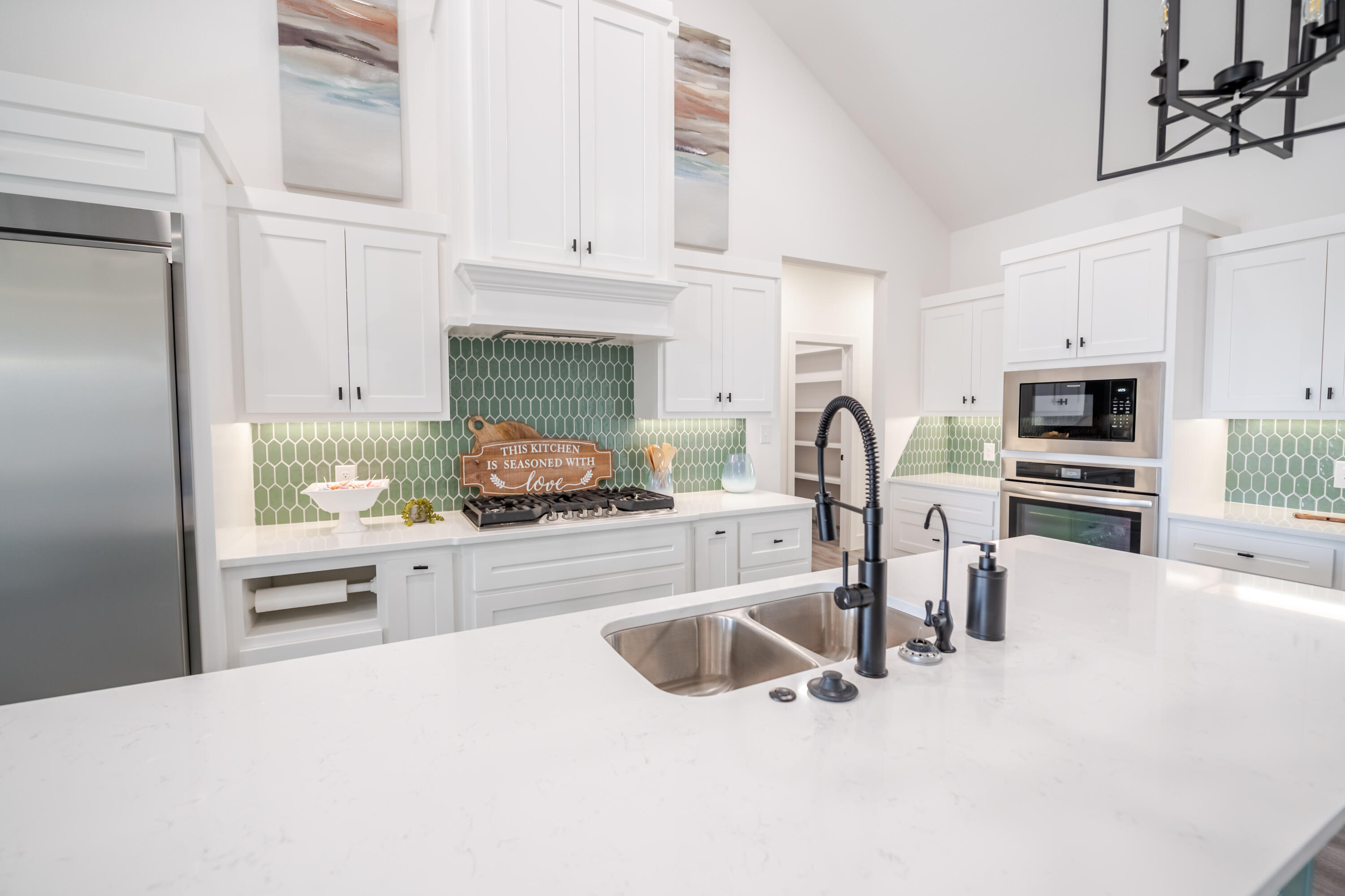 7604 58th Street Lubbock, TX 79407 - Photo 19 of 38 a kitchen with granite countertop a stove a sink and a refrigerator