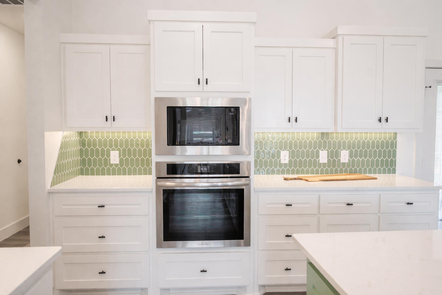 7604 58th Street Lubbock, TX 79407 - Photo 2 of 38 a kitchen with white cabinets and appliances