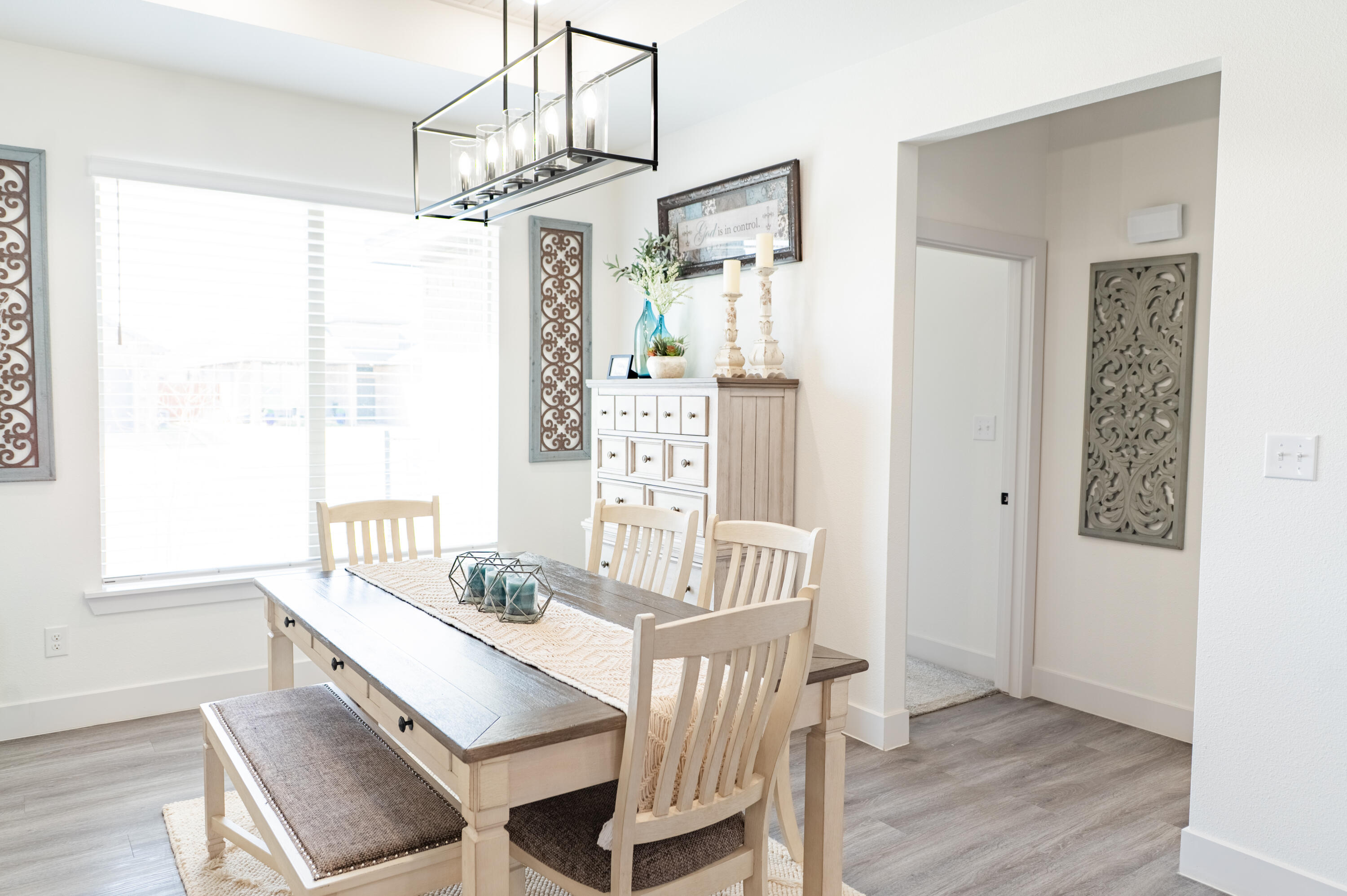 7604 58th Street Lubbock, TX 79407 - Photo 21 of 38 a view of a dining room with furniture window and wooden floor