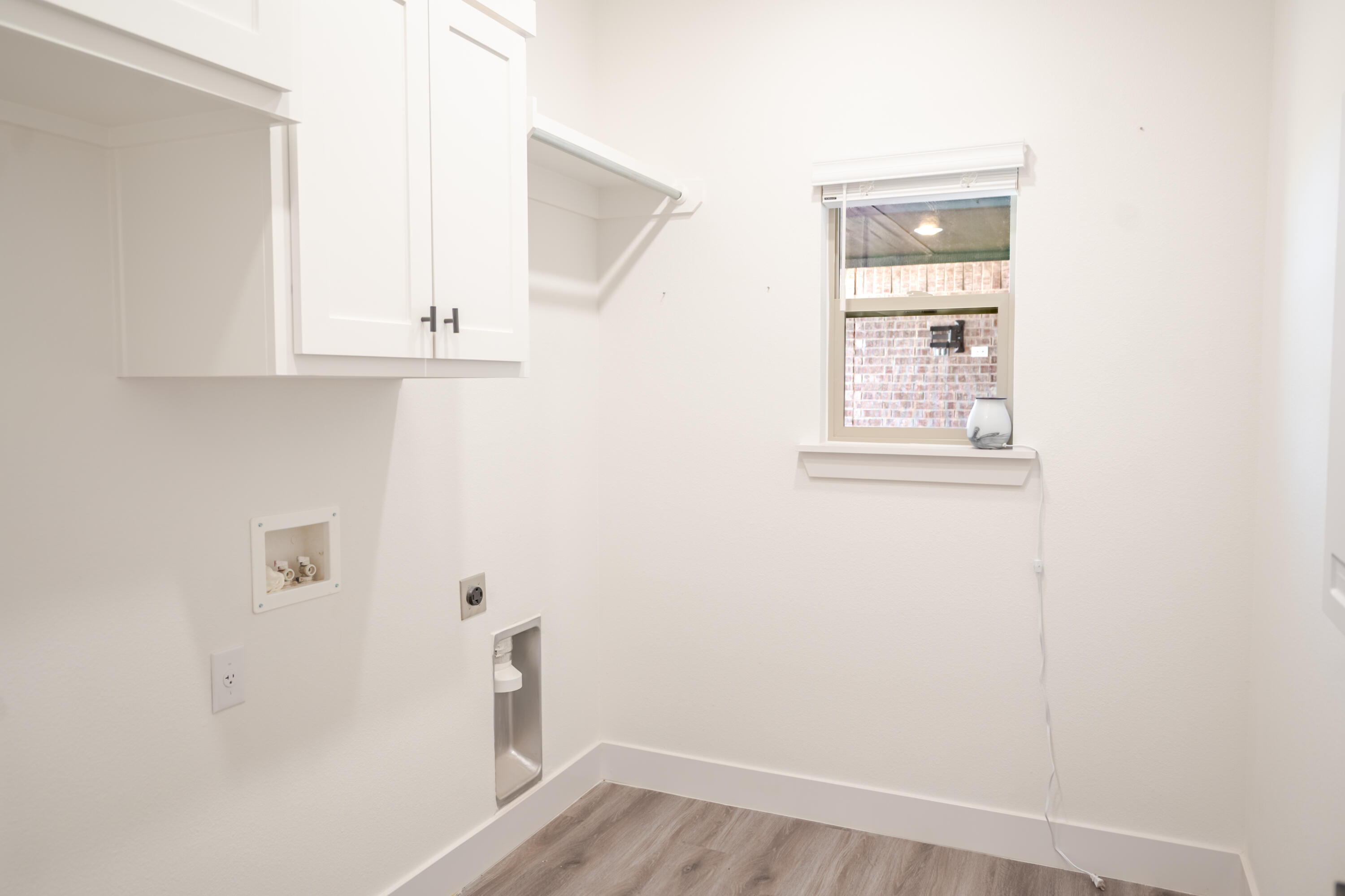 7604 58th Street Lubbock, TX 79407 - Photo 23 of 38 an empty room with wooden floor and window
