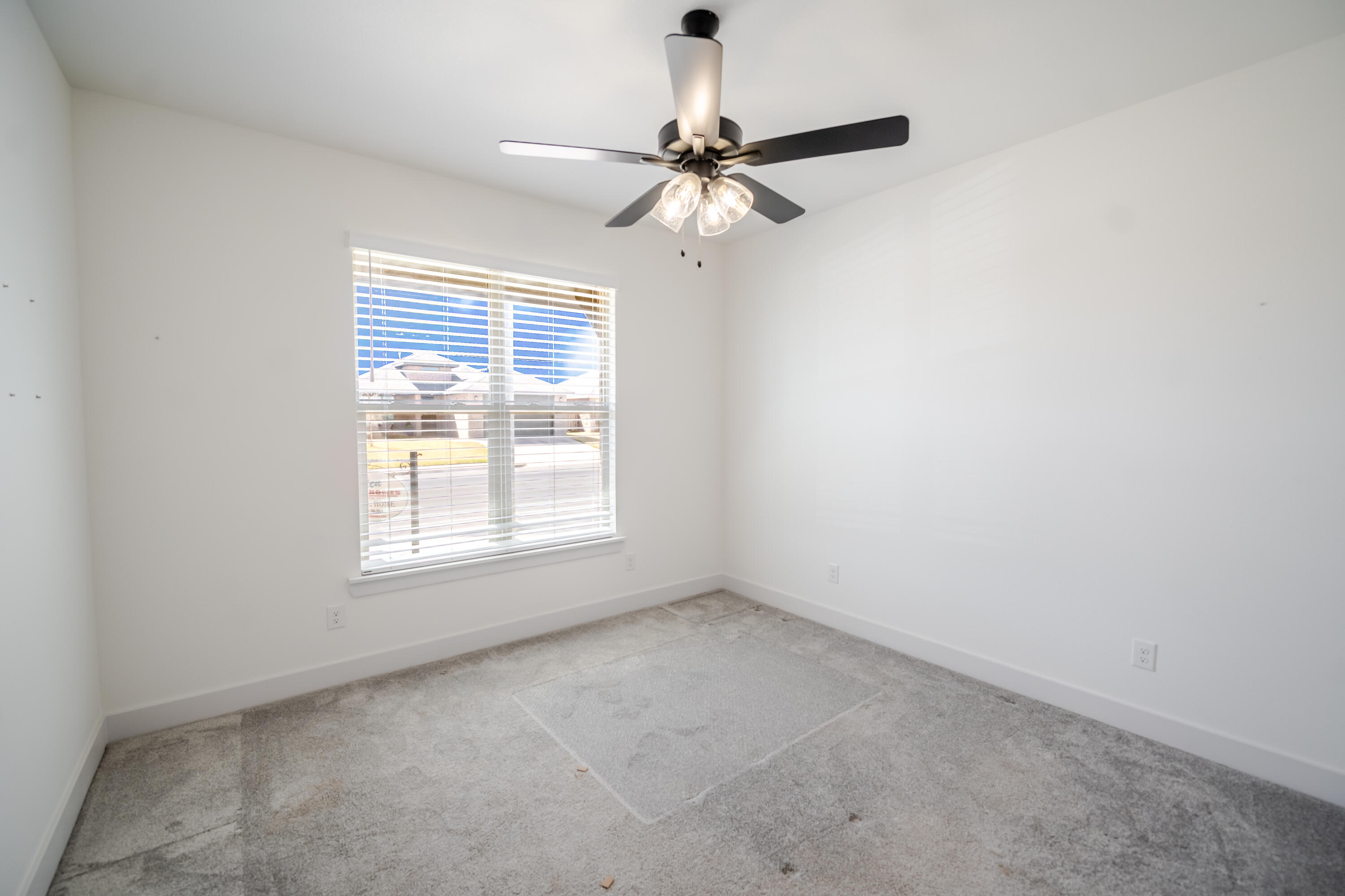 7604 58th Street Lubbock, TX 79407 - Photo 28 of 38 an empty room with a window and a fan