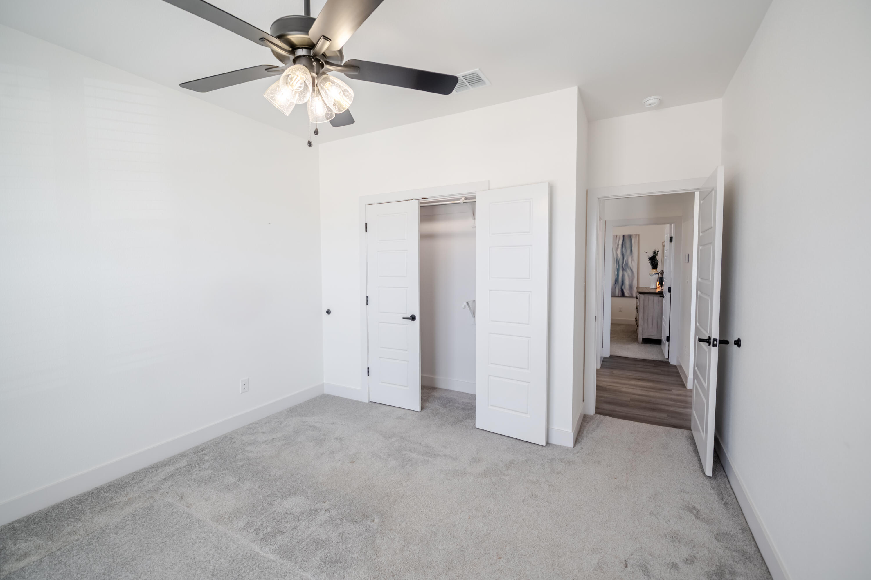 7604 58th Street Lubbock, TX 79407 - Photo 29 of 38 a view of a livingroom with a chandelier fan and a hallway