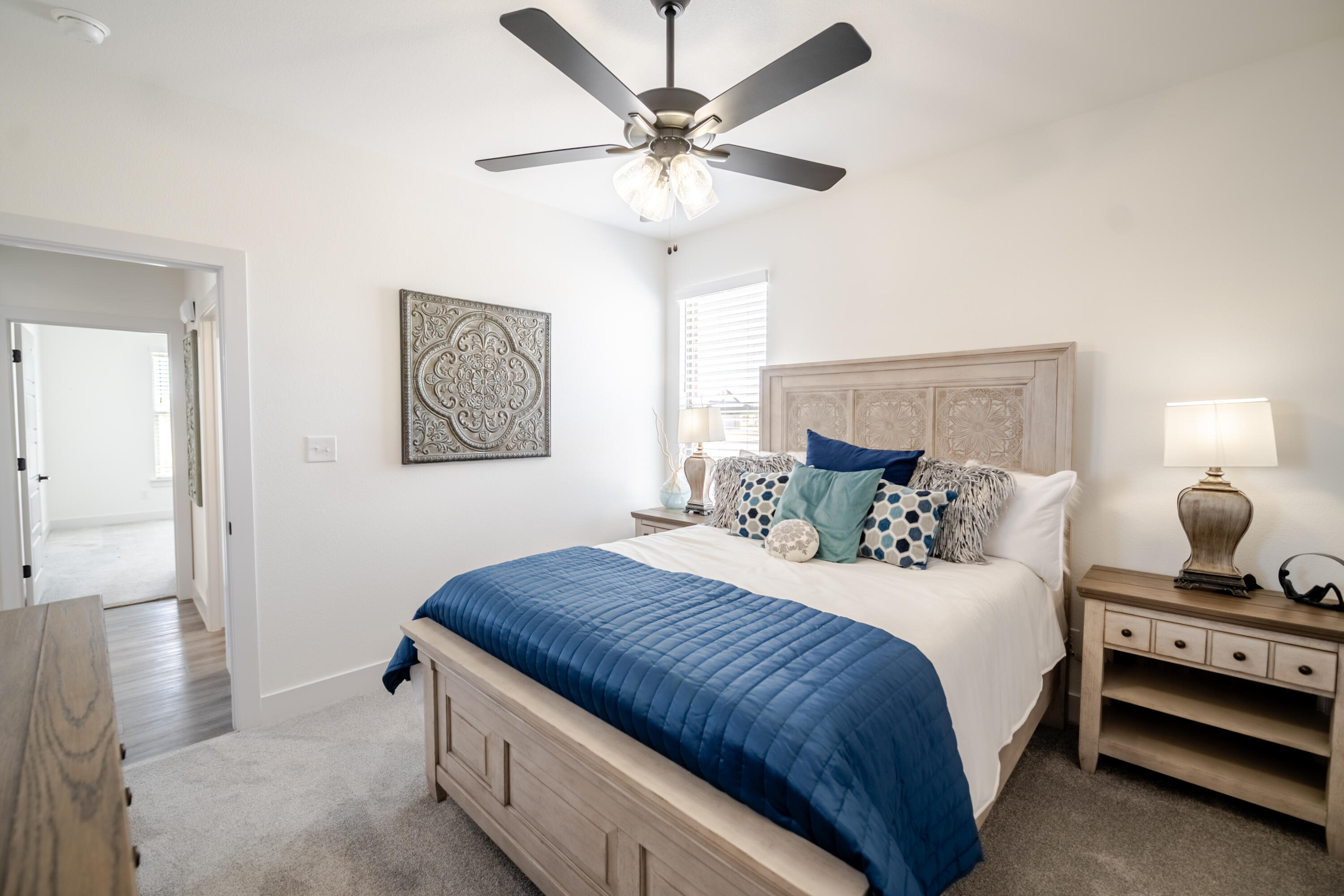 7604 58th Street Lubbock, TX 79407 - Photo 34 of 38 a bedroom with bed and a chandelier