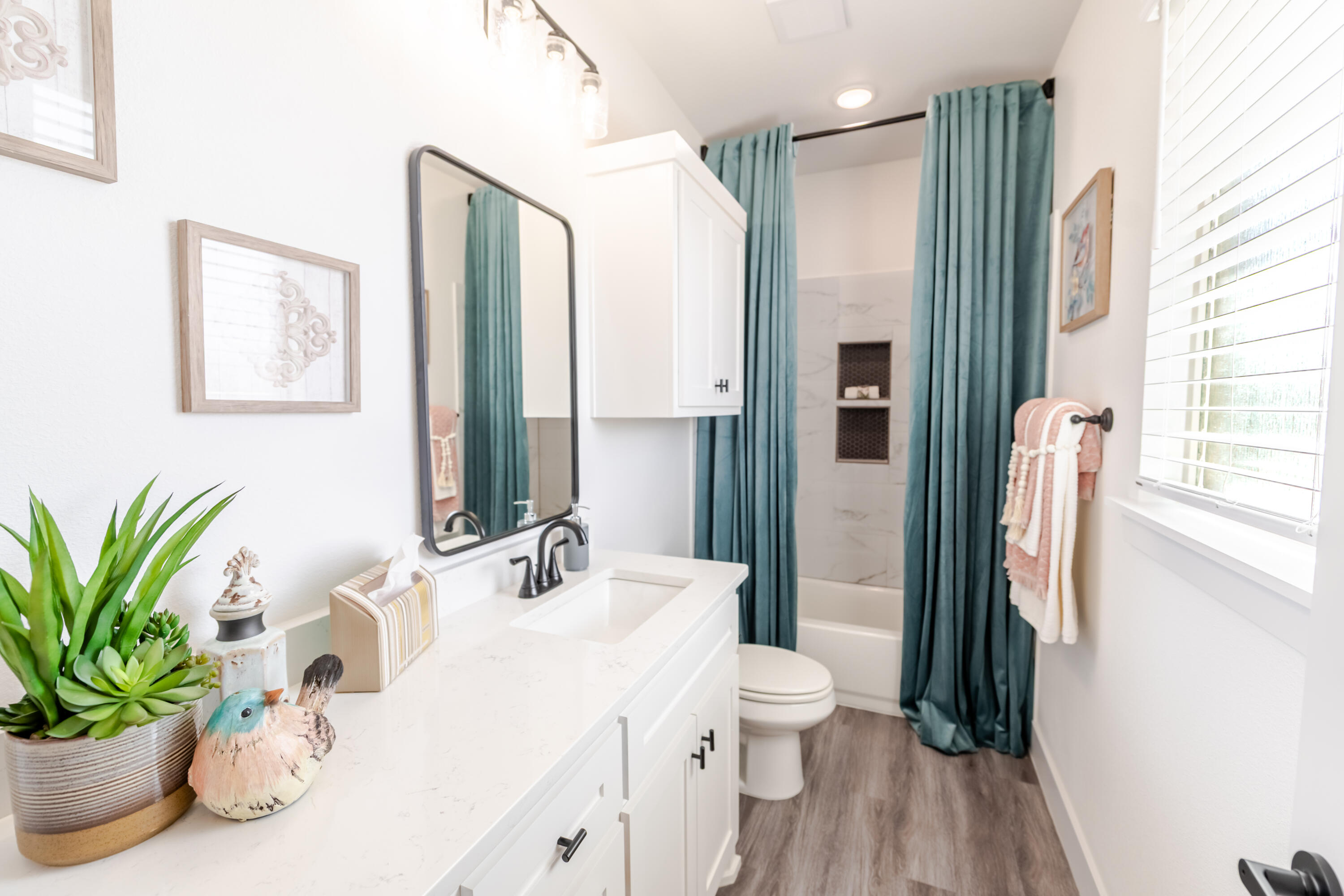 7604 58th Street Lubbock, TX 79407 - Photo 36 of 38 a bathroom with a sink a vanity and a mirror