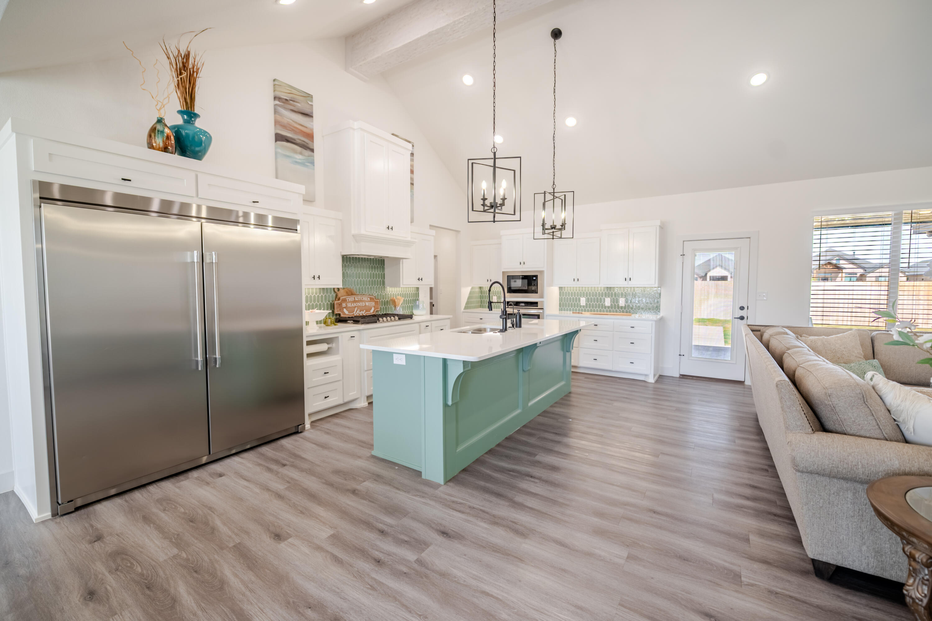 7604 58th Street Lubbock, TX 79407 - Photo 37 of 38 a kitchen with stainless steel appliances kitchen island a refrigerator sink and cabinets
