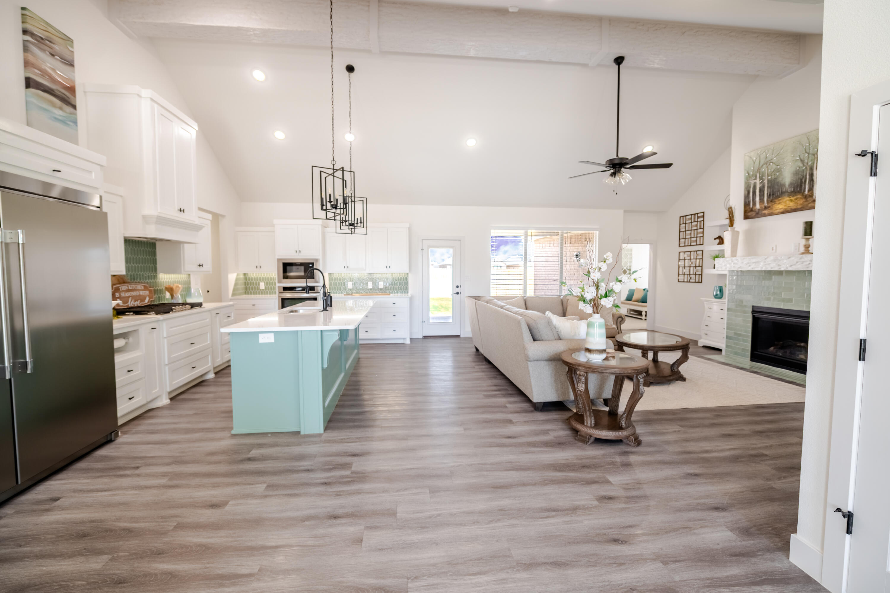 7604 58th Street Lubbock, TX 79407 - Photo 4 of 38 a view of a dining room and livingroom with furniture wooden floor a chandelier