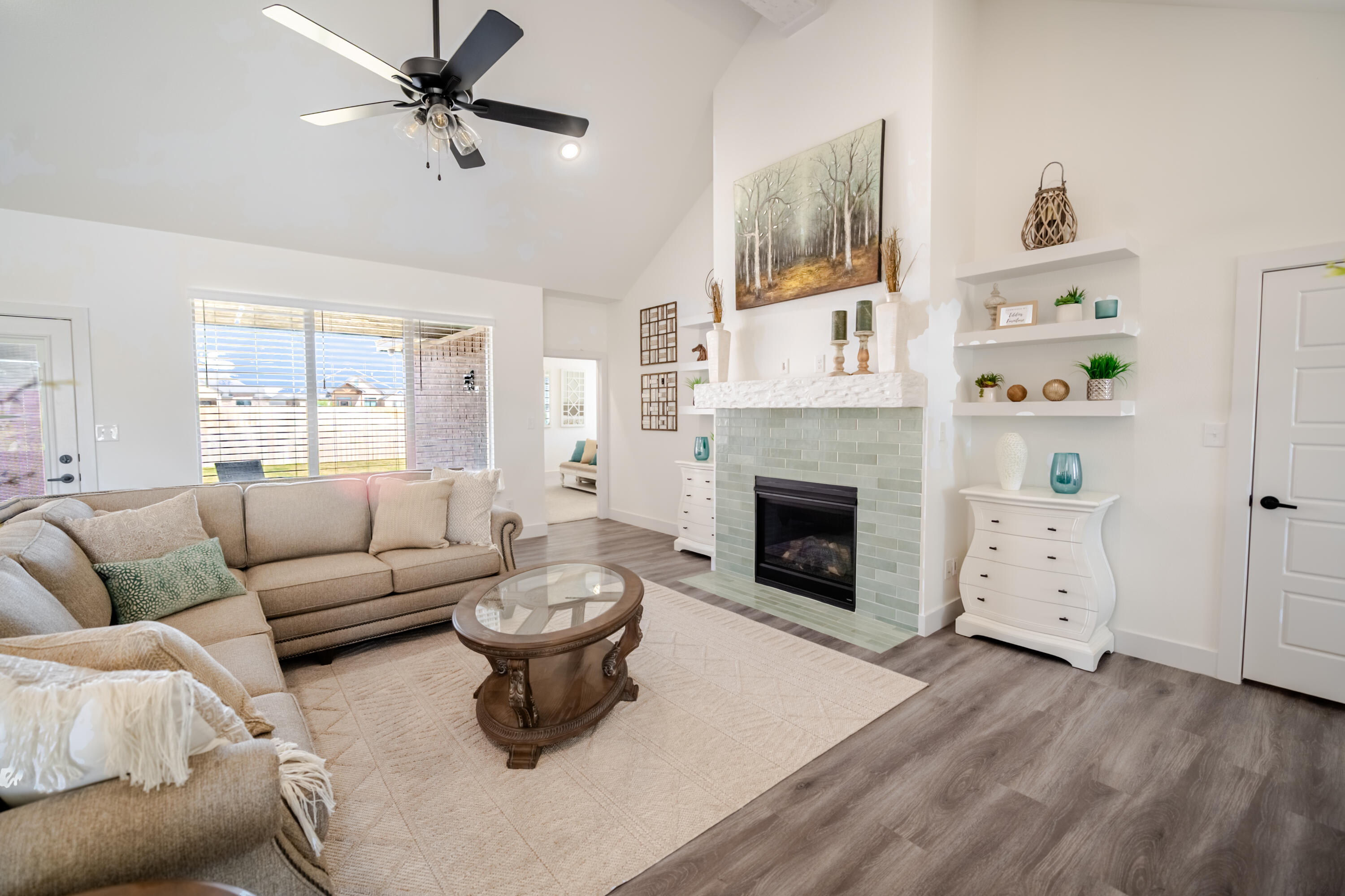 7604 58th Street Lubbock, TX 79407 - Photo 5 of 38 a living room with furniture a window and a fireplace