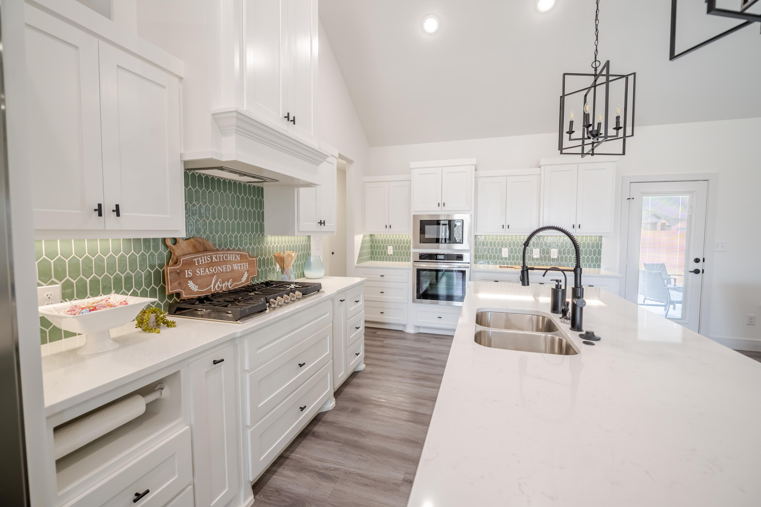 7604 58th Street Lubbock, TX 79407 - Photo 7 of 38 a kitchen with stainless steel appliances a sink stove and cabinets