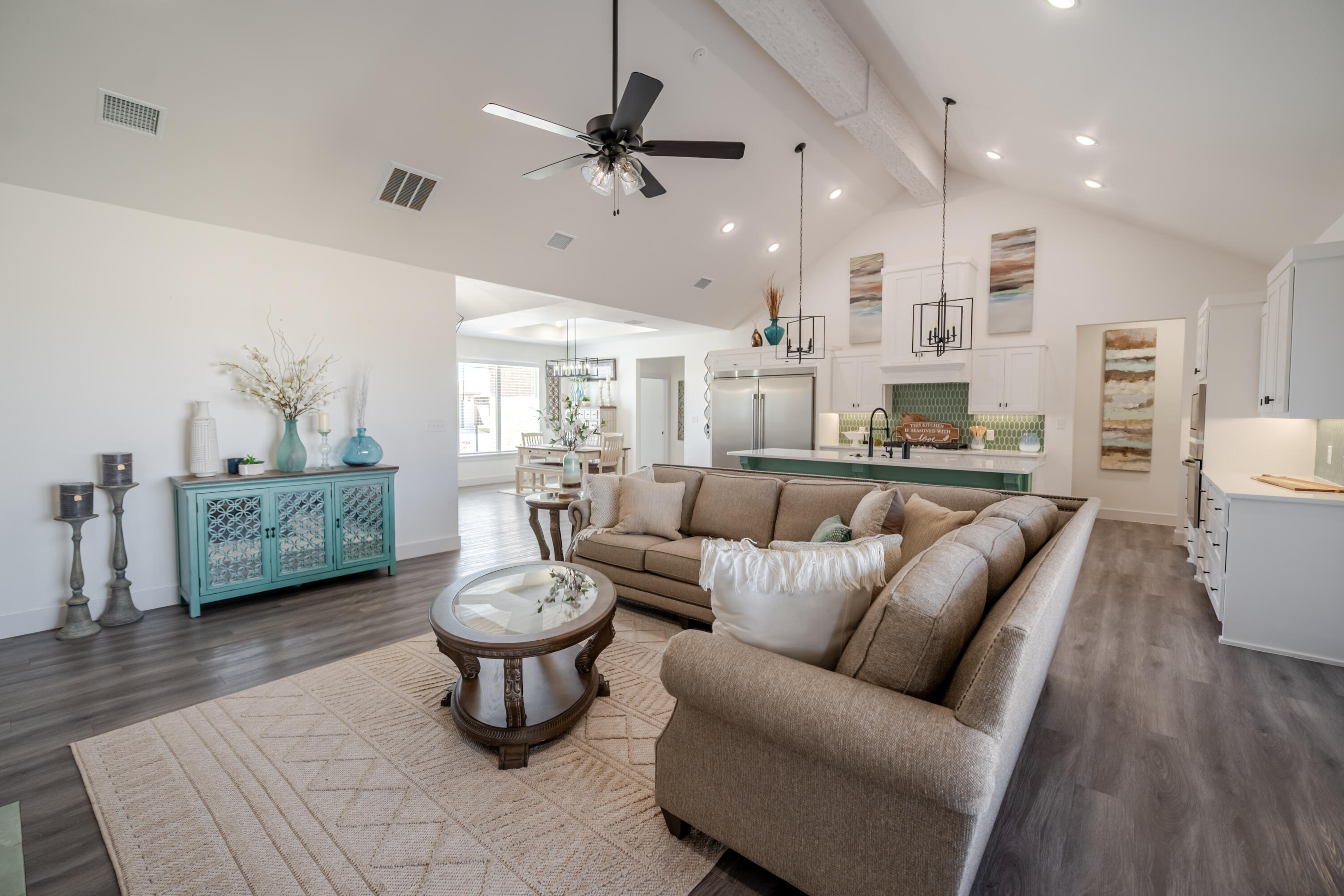 7604 58th Street Lubbock, TX 79407 - Photo 10 of 38 a living room with furniture a rug and a chandelier
