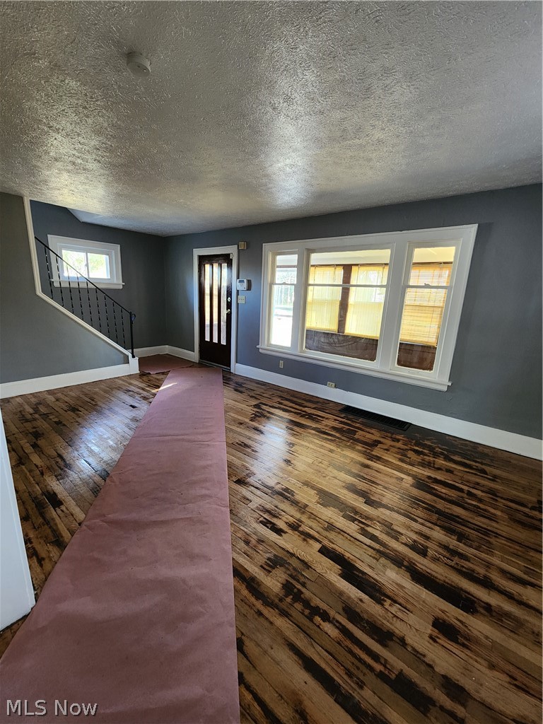 13500 Rugby Road Cleveland, OH 44110 - Photo 5 of 18 Entrance foyer with hardwood / wood-style floors and a textured ceiling