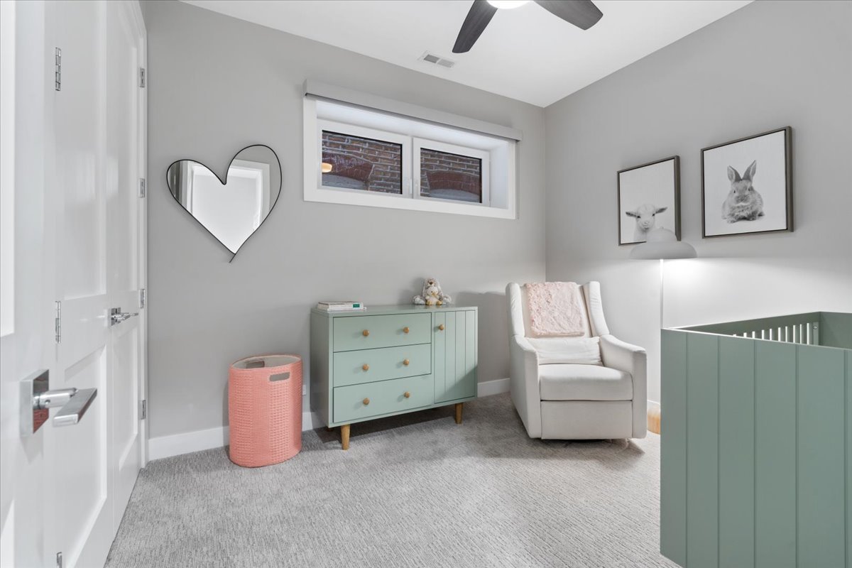 2005 West Huron Street, Unit 1 Chicago, IL 60612 - Photo 20 of 30 a bedroom with a bed and a chandelier