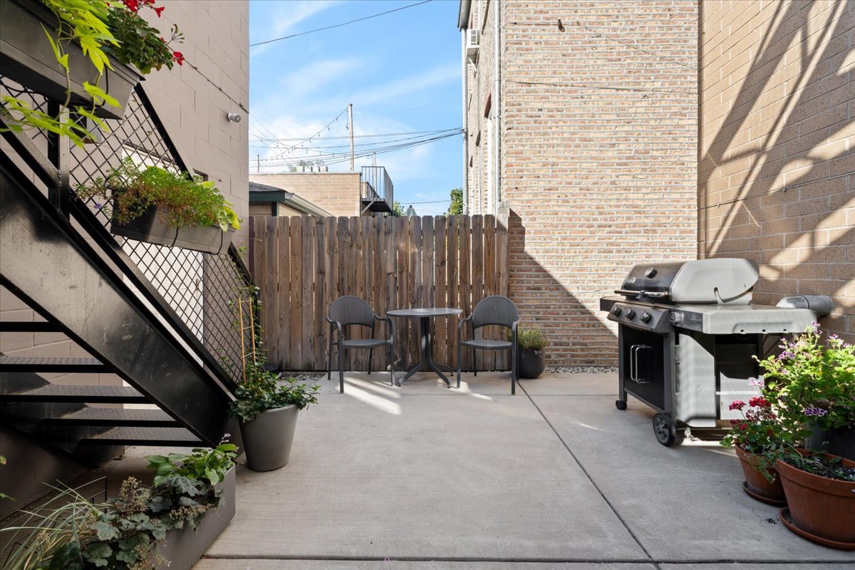 2005 West Huron Street, Unit 1 Chicago, IL 60612 - Photo 26 of 30 a view of a patio with chairs and potted plants