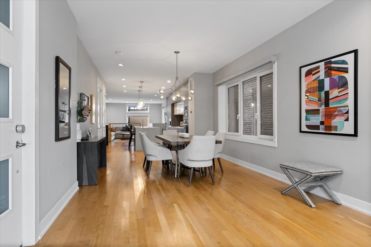 2005 West Huron Street, Unit 1 Chicago, IL 60612 - Photo 5 of 30 a living room with furniture a wooden floor and a large window