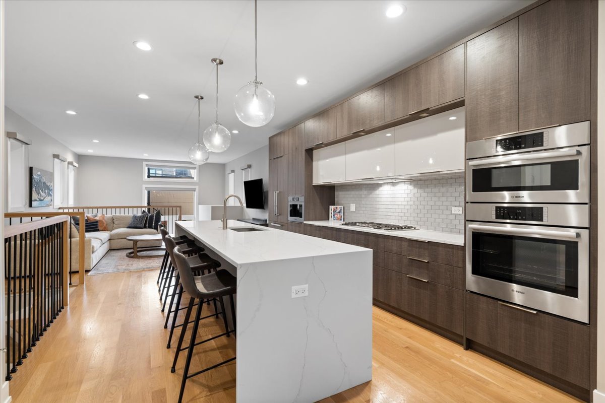 2005 West Huron Street, Unit 1 Chicago, IL 60612 - Photo 8 of 30 a kitchen with stainless steel appliances granite countertop a sink a stove and a refrigerator