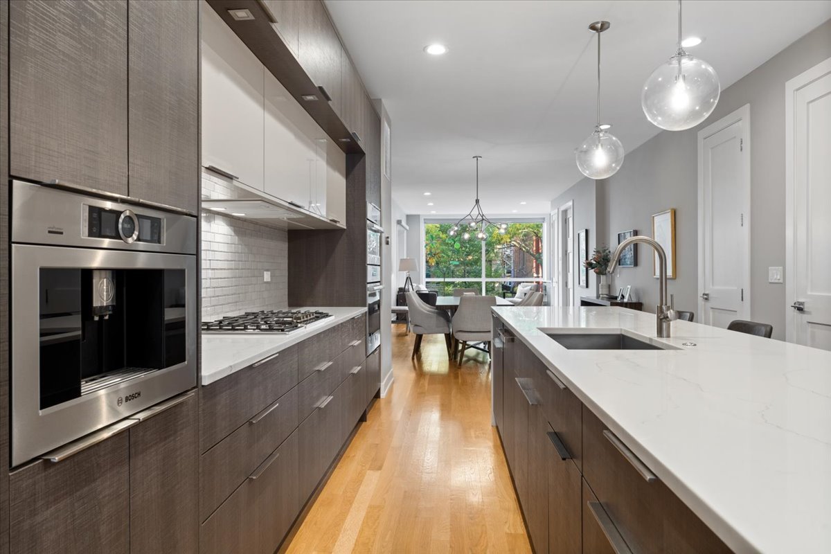 2005 West Huron Street, Unit 1 Chicago, IL 60612 - Photo 10 of 30 a very nice looking kitchen with stainless steel appliances granite countertop a sink a stove and a wooden floors